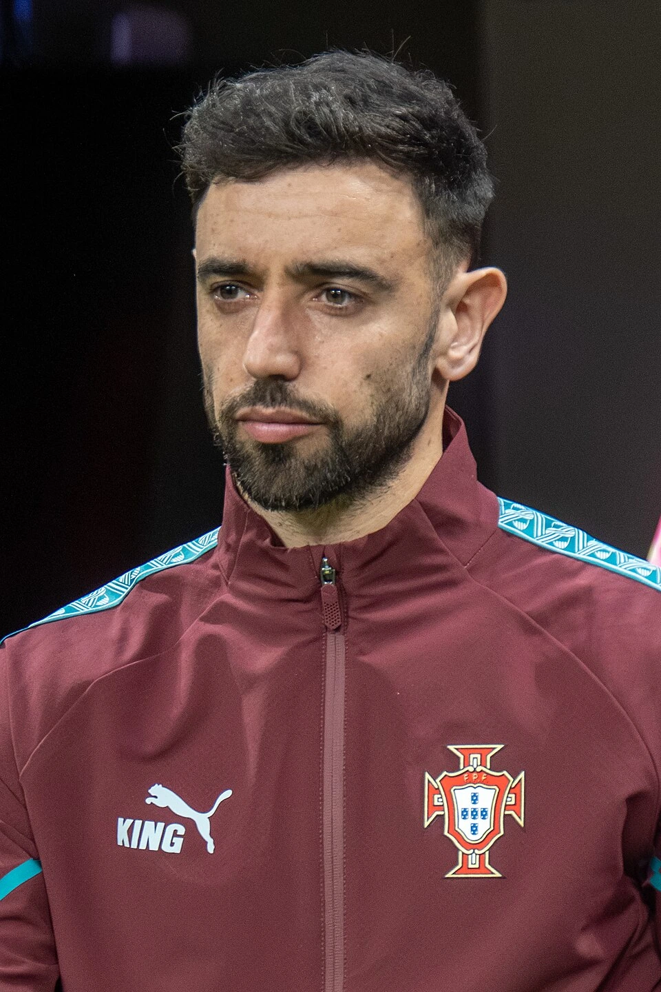 Bruno Fernandes of Portugal in a match-day portrait, wearing a maroon Portugal training jacket.