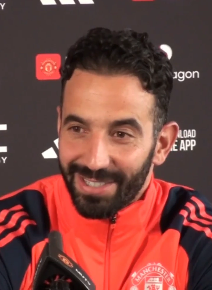 Rúben Amorim speaking at a Manchester United press conference in a red training top